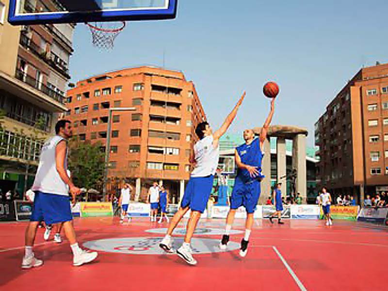 Basketball players in action on the mobile floor